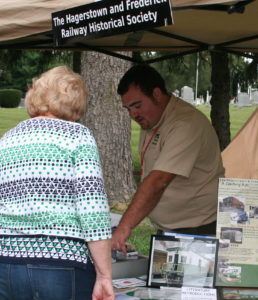 Reuben Moss discusses artifacts with a visitor at Middletown